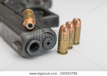Hand Gun Up Close With Ammuntion Laying Around It