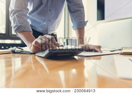 Business And Finance Concept Of Office Working, Businessman Using Calculator To Discussing Sale Anal