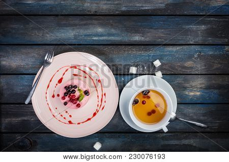 Caramel Cheesecake With Strawberry With Cup Of Tea And Cutlery On The Wooden Background Top View