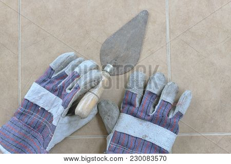 Towel And Construction Gloves On The Floor. Top View.