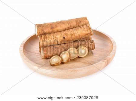 Fresh Burdock Root Or Gobo In Wooden Plate And On White Background