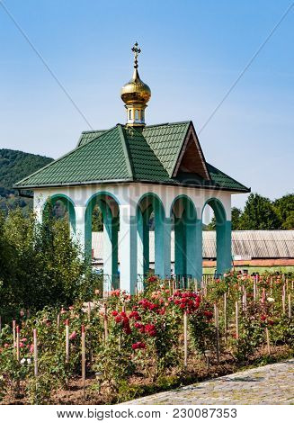White church with gold domes a part of the European architecture. Russian orthodox church with typical golden onion domes