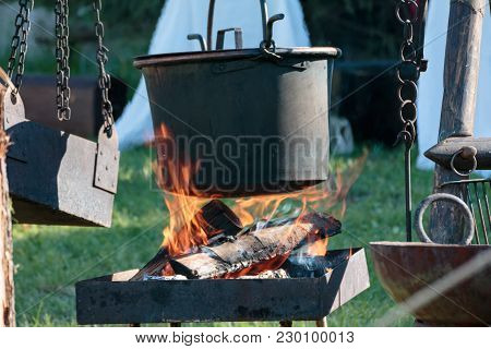 Black Cauldron On Bonfire In Camping In Summer Time