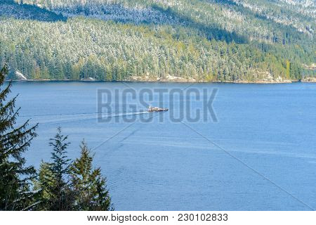 Fantastic view over ocean, snow mountain and rocks at Sechelt inlet in Vancouver, Canada.