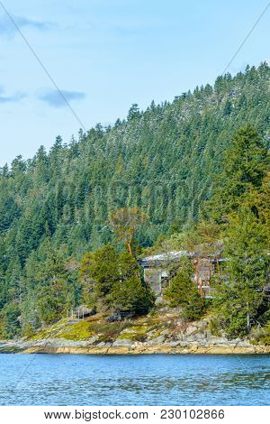 Fantastic view over ocean, snow mountain and rocks at Sechelt inlet in Vancouver, Canada.