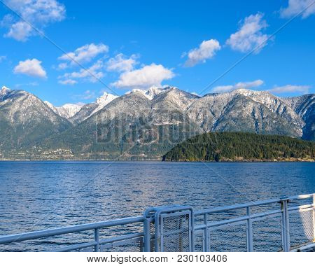 Fantastic view over ocean, snow mountain and rocks at Sechelt inlet in Vancouver, Canada.