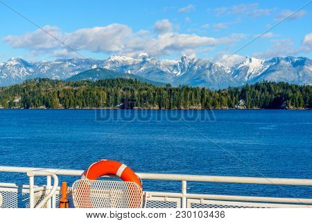 Fantastic view over ocean, snow mountain and rocks at Sechelt inlet in Vancouver, Canada.