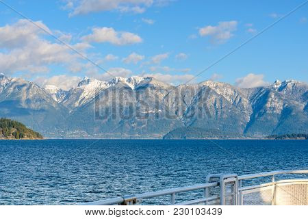 Fantastic view over ocean, snow mountain and rocks at Sechelt inlet in Vancouver, Canada.