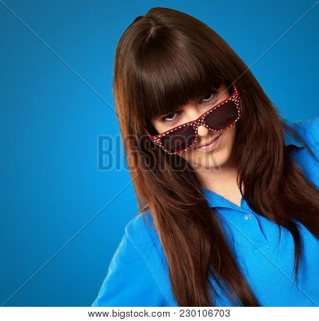 Teenage Girl With A Big Glasses On Blue Background