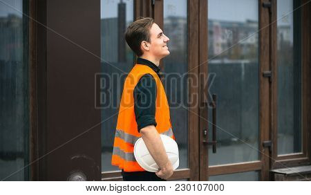 The Engineer Holding The White Helmet Safety At Construction Site With Crane Background Silhouette