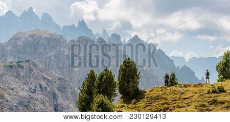 Scenic Mountain Hiking. Two Caucasian Hikers On The Dolomites Trailhead.