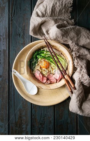 Asian Dish Udon Noodles With Egg Yolk, Sesame, Mushrooms, Boc Choy, Sliced Sous Vide Cooked Meat Ser