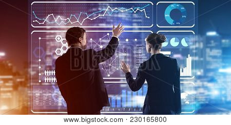 Two Business People Standing With Back And Working Together With Virtual Screen