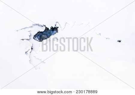 Broken Ice In Shape Of A Scorpion In Frozen Water Of Lake