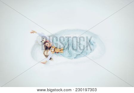 The Spring Has Woken Up, The Woman Lays In A Snow Covered With A Blanket, Soft Fluffy And Cozy Dream