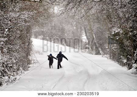 Bannow County Wexford Ireland - March 2 2018; Couple Playing On Winter Road Covered In Snow.