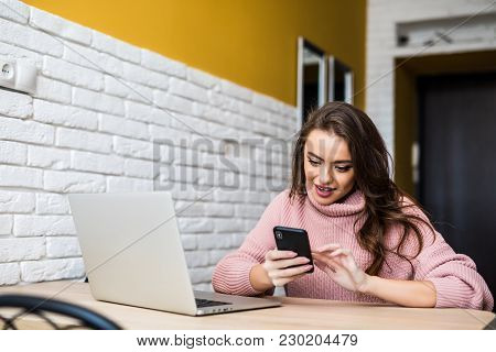 Beautiful Girl Laughing Using Multiple Devices On A Table At Home