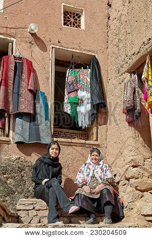 Abyaneh, Iran - April 26, 2017: Two Iranian Women Are Sitting In A Traditional Village In The Mounta