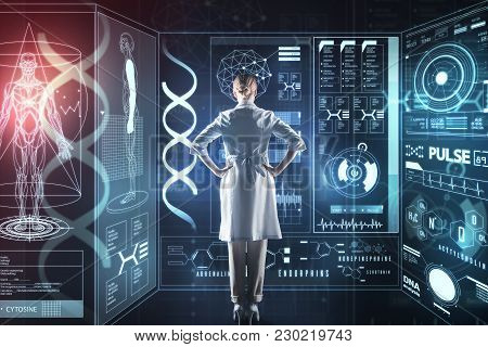 Feeling Ready. Clever Qualified Progressive Doctor Standing With Her Hands On The Hips And Feeling C