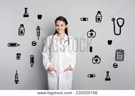 Pretty Doctor. Cheerful Smart Young Doctor Feeling Happy And Smiling While Having The First Day At W