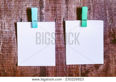 Paper Attach To Rope With Clothes Pins On Wooden Background