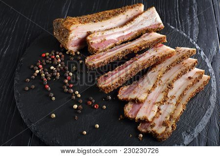 Speck Cut In Slices On Black Slate