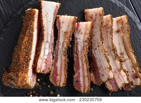 Close-up Of Spicy Smoked Speck Cut In Slices