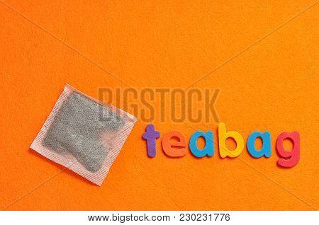 A Teabag With The Word Teabag On An Orange Background