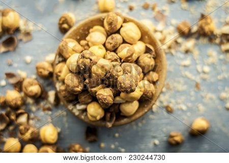 Close Up Of Baked Or Roasted Chickpea/channa Or Dalia In A Bowl On A Blue Surface.