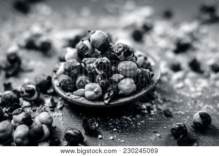 Close Up Of Baked Or Roasted Chickpea/channa Or Dalia In A Bowl On A Blue Surface.