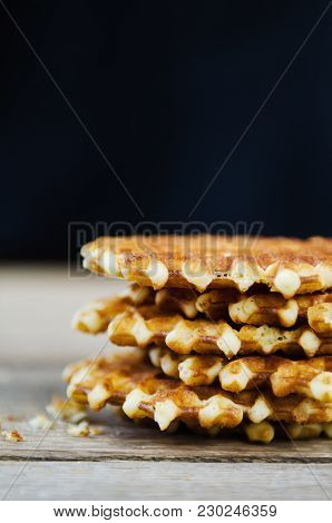 Homemade Fresh Waffles Stacked On A Wooden Table Black Background