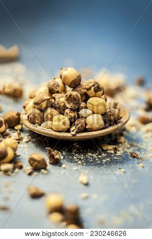 Close Up Of Baked Or Roasted Chickpea/channa Or Dalia In A Bowl On A Blue Surface.