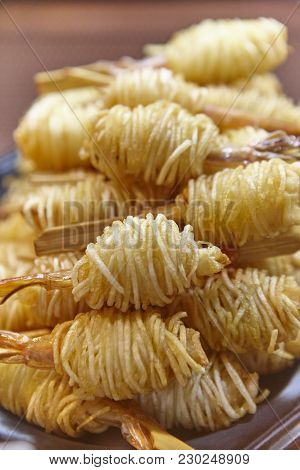 Scampi Prawms Covered With Thin Fried Potatos. Delicious Cuisine. Vertical