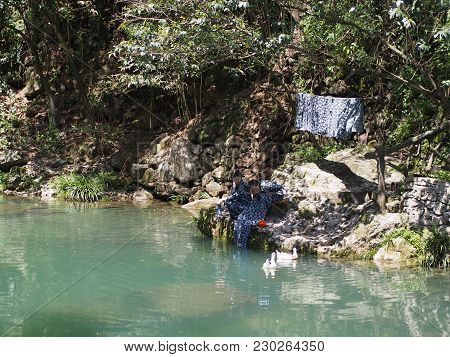 Chinese Lady Washing Her Clothes At The River At The Local Village Nearby Three Gorges Dam. Travel I