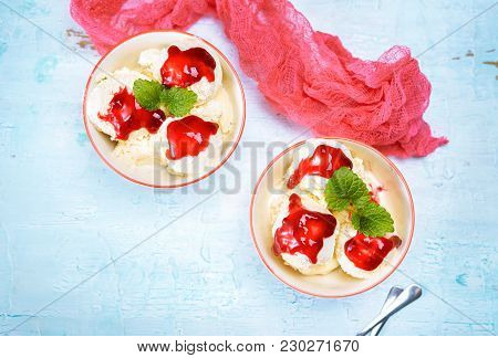 Top View Of Delicious Vanilla Ice Cream Balls In Two Bowls Poured With Cherry Sauce. Copy Space