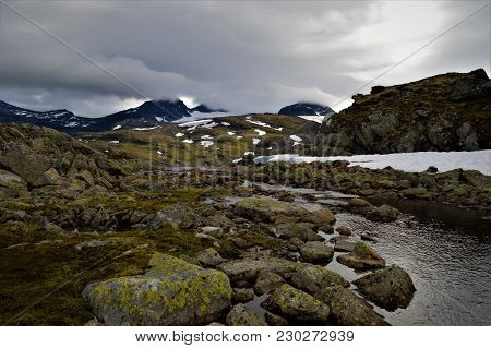 Small Stream And Mountains In Norway National Park