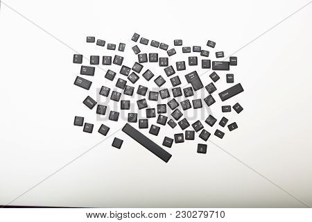 Loose Alphanumeric Covers For The Keys On A Computer Keyboard In A Random Jumble On A White Or Light