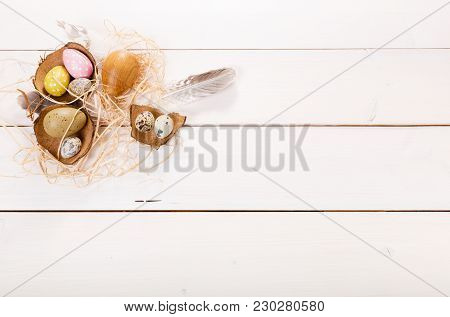 Easter Background With Easter Eggs, Bird Feather And Spring Flowers. Top View With Copy Space