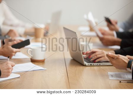 Business People Sitting Together At Conference Table Office Desk Using Laptops And Smartphones Worki