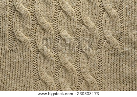 Knit Texture of Beige Wool Knitted Fabric with Cable Knits Pattern. Blank Background