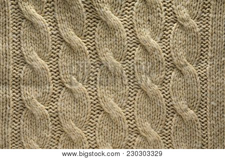 Knit Texture of Beige Wool Knitted Fabric with Cable Knits Pattern. Blank Background
