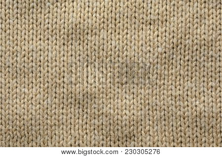 Knit Texture of Beige Wool Knitted Fabric with Regular Pattern. Knit Sweater Blank Background