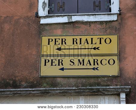 Venice Italy Road Sign With Indication To Railto Bridge Or Saint Mark Square With Two Black Arrows
