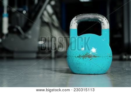 Old Heavy Used Blue Kettle Bell On The Gym Floor Ready For Hard Core Strength And Conditioning Worko