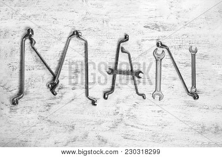 The Inscription Man Is Written By Work Tools. The Word Man Is Made Up Of A Work Tools.