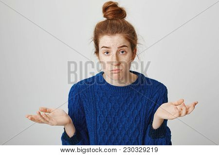 There Is Nothing I Can Do. Indoor Shot Of Gloomy Confused Woman With Red Hair And Freckles In Winter