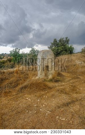 Monolythic Standing Stone In A Field In Countryside In Cyprus.