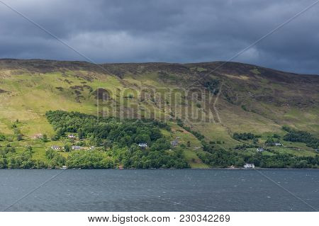 Ullapool, Scotland - June 8, 2012: Hills On West Shore Of Loch Brrom Near Ullapool Is Green And Brow