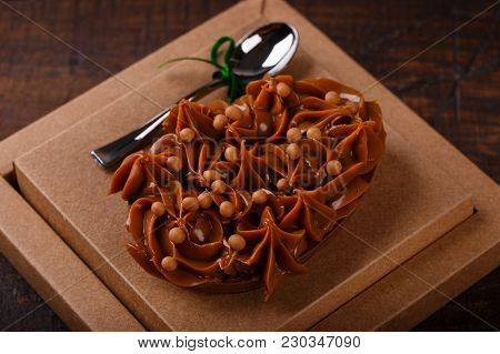 Chocolate Egg Ith Filling For Easter On Wooden Background
