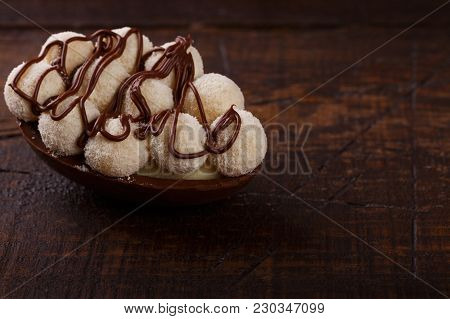 Chocolate Egg Ith Filling For Easter On Wooden Background